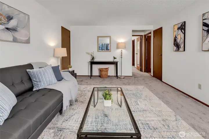 Living room with flexible layout for TV, seating, and entertaining. Extra closet off hall for even more storage.
