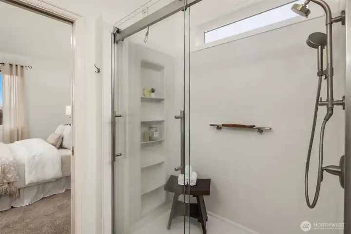 Convenient built-in storage shelves. A high window offers privacy and natural light.