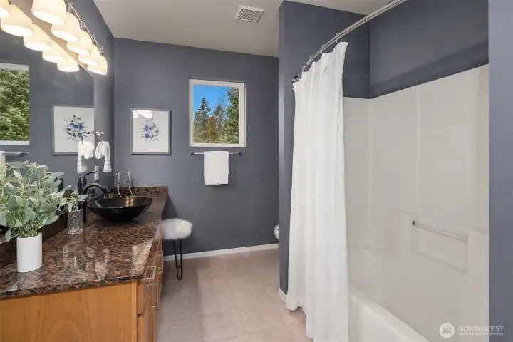 Large lower-level full bath with access from the bedroom as well as the recreation room.