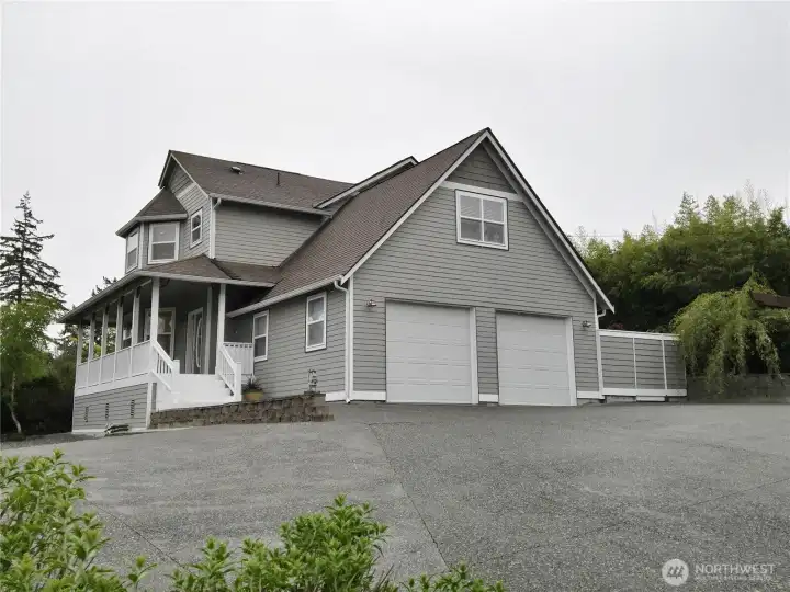 Cap Cod style home with wrap around front deck and views to the water and mountains
