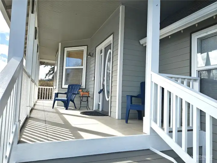 Brand new front steps leading to the front door and deck continues around the south side of the house