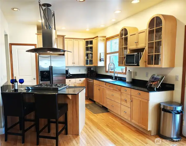 Gourmet's delight in this open plan kitchen. Featuring maple cabinets, Granite counter tops, stainless steel appliances and custom stainless hood for gas stove.