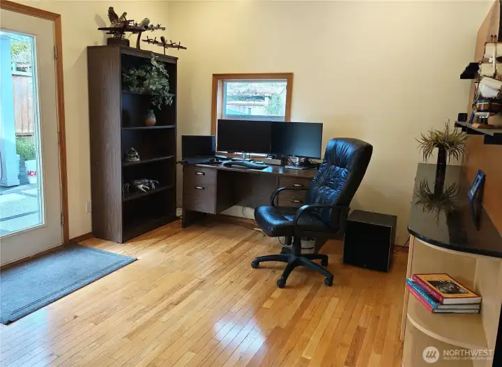 Sitting area/ breakfast room located adjacent to the kitchen. Features custom built in cabinetry and shelving that conveys. Display your artwork, wine collection etc. great for serving drinks or appetizers. Currently used for an office.