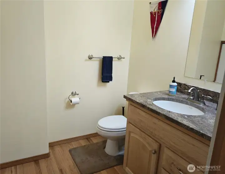 Roomy Powder room with granite counters.