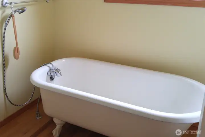 Primary bathroom. Unique claw foot tub originally from historic Rosario resort on Orcas island