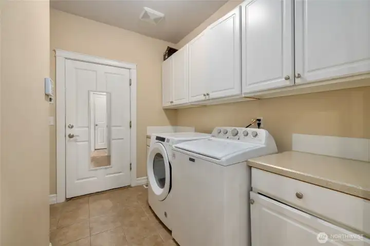 Laundry Utility room with extra storage and counter space. Leads to garage.