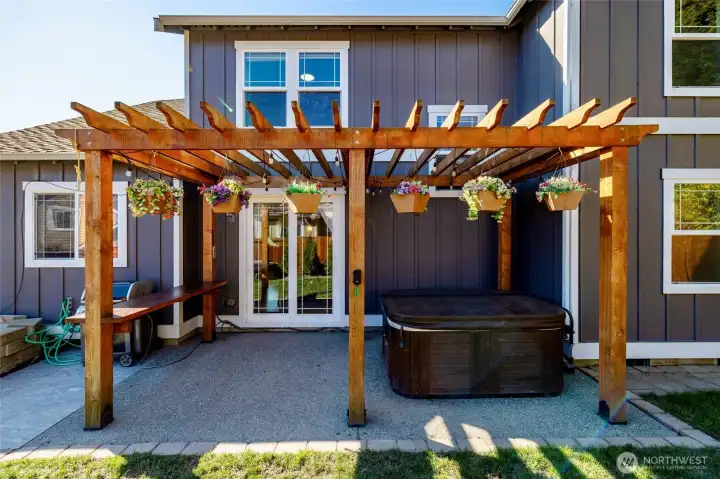 Pergola in backyard with room for gardening, play, or relax in the hot tub.