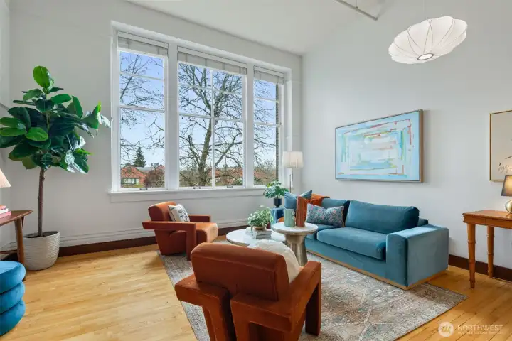 Beautiful hardwood floors anchor the lofted ceiling