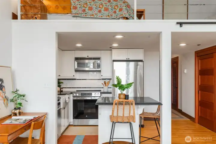 With condo approval, you could add stairs to loft on this side of kitchen