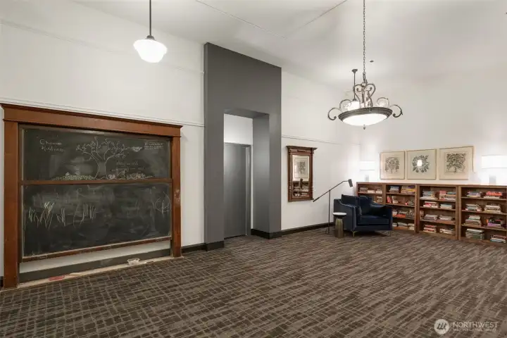 The 4th floor has it all!- This riginal schoolhouse chalkboard frames this community library space on the 4th floor.  Also on same floor- laundry and access to the HUGE rooftop deck
