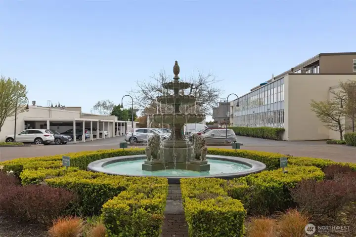 This beautiful fountain adorns the back parking area. The assigned parking for this condo is to the left of this photo, adjacent to rear entry of building This beautiful fountain adorns the back parking area. The assigned parking for this condo is to the left of this photo, adjacent to rear entry of building