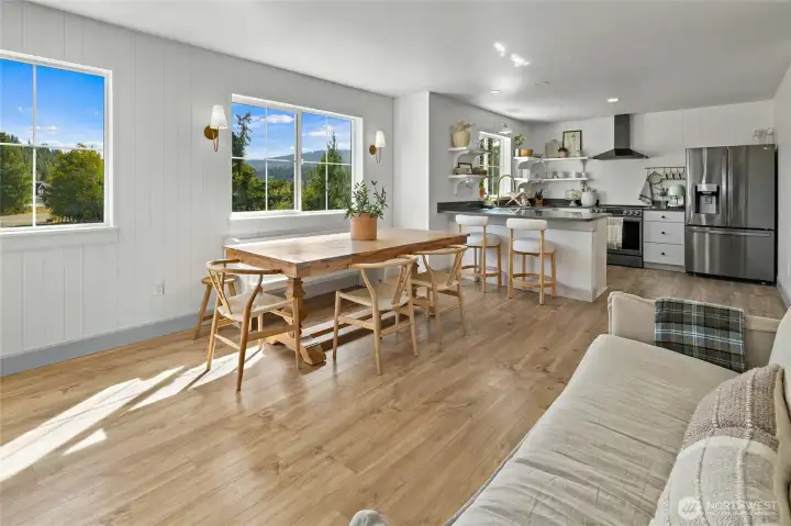 A blend of modern vertical paneling and brass sconces adds texture and style to the living area.
