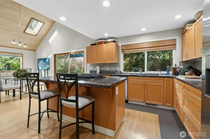 Chef’s kitchen featuring stone surfaces, gas cooktop & newer appliances