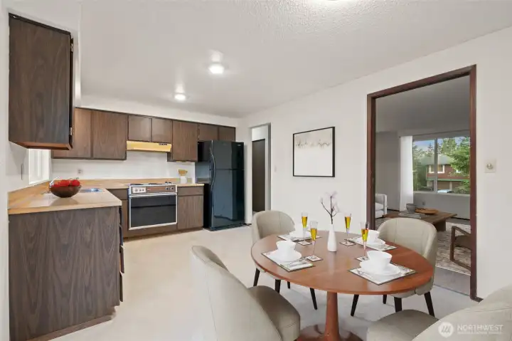 Eat in kitchen with new floors and lighting off slider to deck - Virtually staged to give you a sense of the potential!