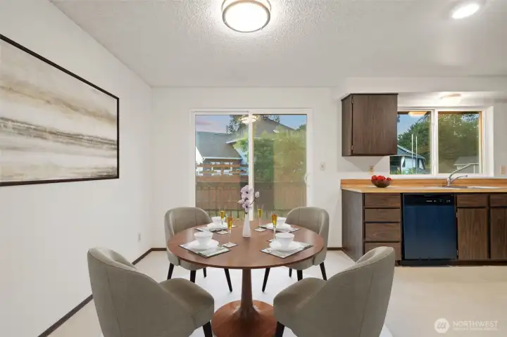 Eat in kitchen with new floors and lighting off slider to deck - Virtually staged to give you a sense of the potential!