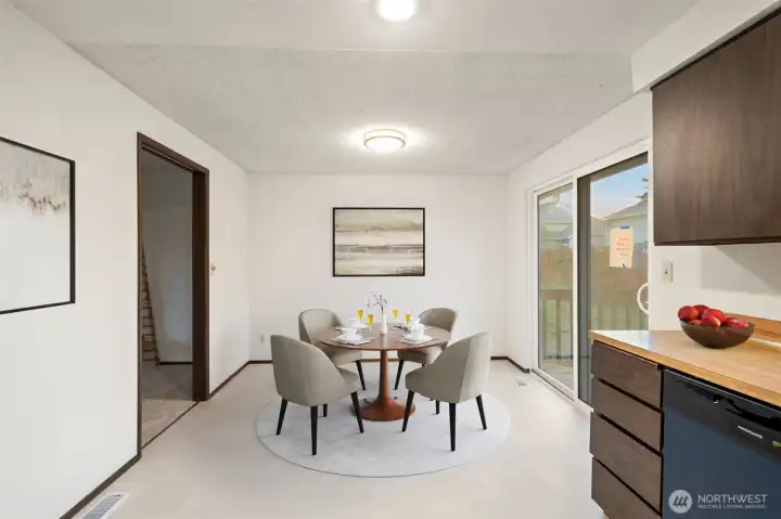 Eat in kitchen with new floors and lighting off slider to deck - Virtually staged to give you a sense of the potential!
