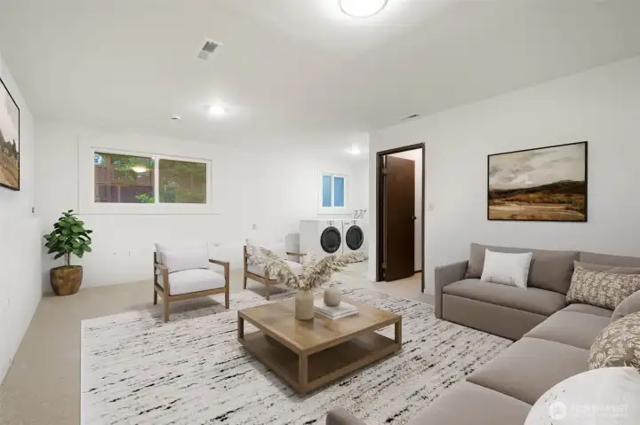 Lower level recreation room with wood burning fireplace. Fresh paint, insulation, lighting & flooring! Virtually staged to demonstrate size and options. Right off laundry & garage.