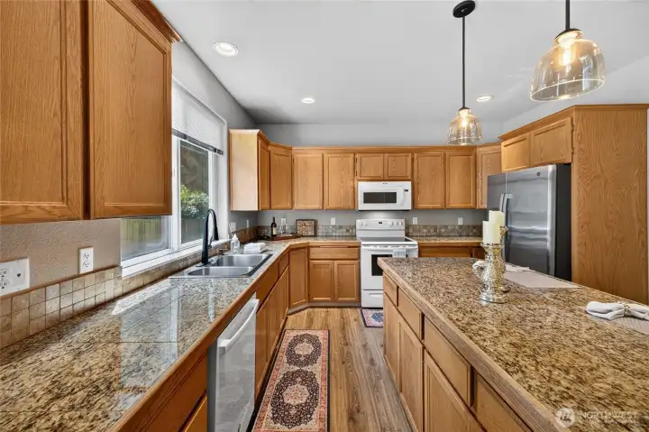 Fabulous Kitchen with Oak Cabinets with Pull-Outs, Dine at Island and Granite Countertops. Newer Dishwasher and Refrigerator.