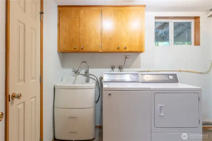 Laundry has lots of space for fluffing and folding and utlity sink.