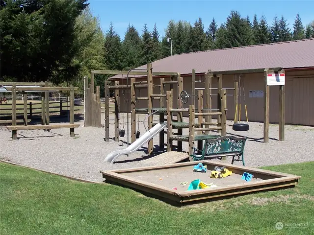 Crystal River Ranch Home Owners Assn playground with community center in the background.