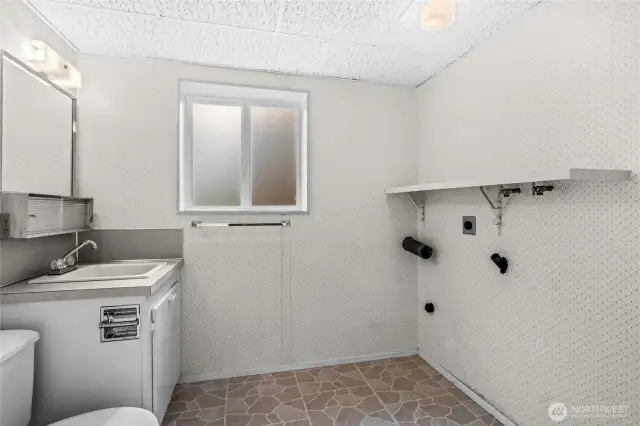 1/2 Bath and Utility Room. Plenty of room for the Newer Huge Washer and Dryers