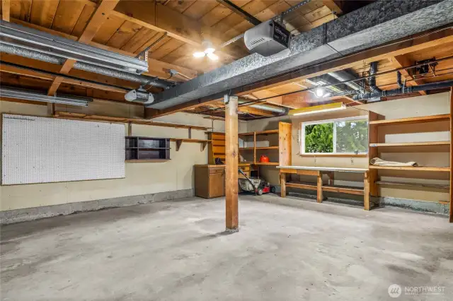550 sqft Garage with shelving and Workbench and Outside Access Door which many homes lack