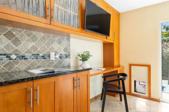 Desk space, cabinet mounted tv, tile backsplash, doggy door.