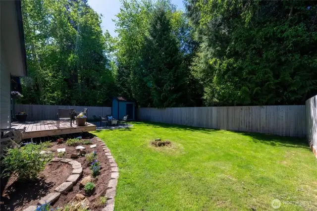 With vibrant landscaping and a manicured lawn, this backyard is ready for summer BBQs, morning coffee, or cozy nights by the fire.