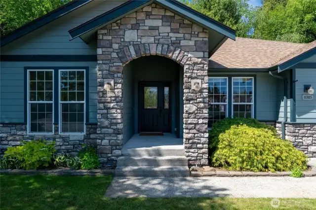 Welcome guests with style through this beautifully crafted stone-arched entryway that adds timeless curb appeal to the home’s exterior.