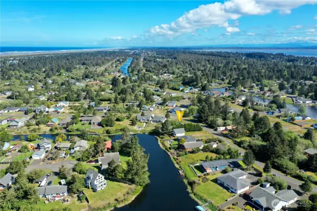 This captivating aerial photo showcases the expansive layout of 137 N Razor Clam Dr SW, nestled along the Bell Canal in Ocean Shores, WA. The property boasts direct canal access, offering unparalleled opportunities for boating, kayaking, and enjoying serene waterfront living.
