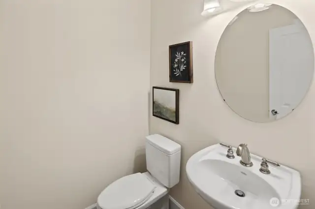 The convenient powder room off the kitchen is placed for easy access and ideal for guests.