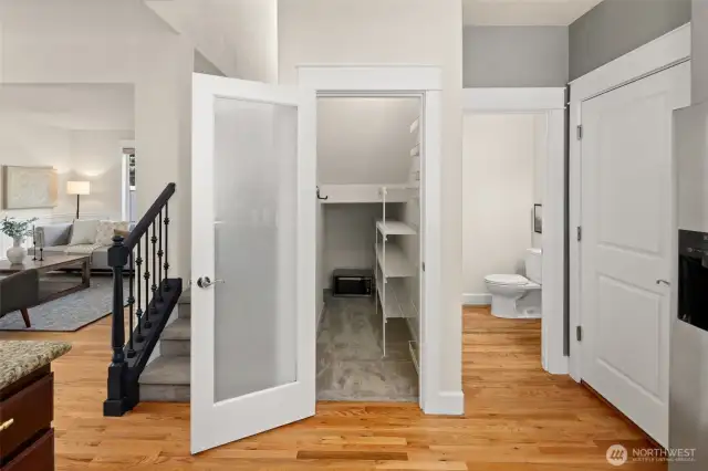 Just off the kitchen, you’ll find a spacious walk-in pantry, main floor powder room, and handy access to the three-car garage.