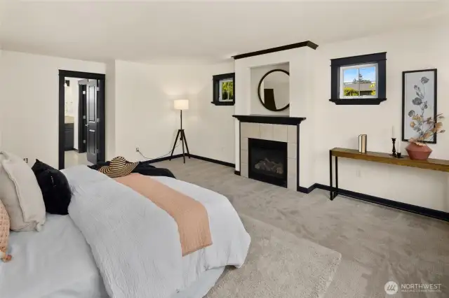 Wake up to treetop views and end your day by the fire—this primary bedroom delivers both space and serenity.