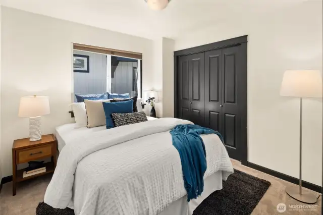 Fresh carpet, freshly painted trim, and ample closet space make this comfortable guest bedroom a welcoming retreat.