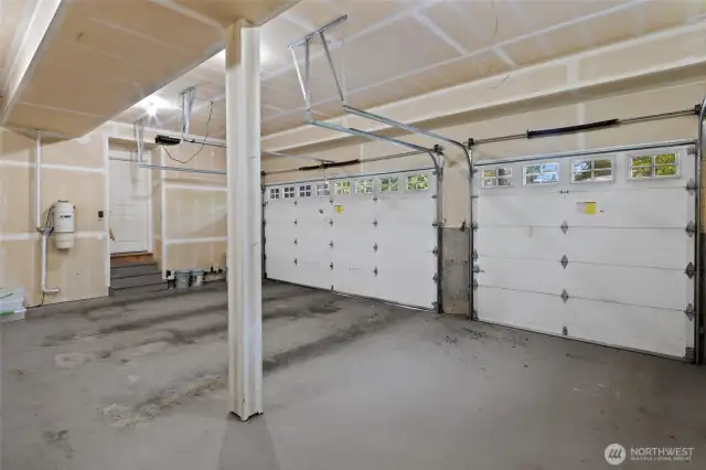 Expansive THREE-car garage with room for much more beyond cares: storage, workbench, or weekend projects.