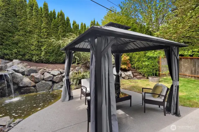 Enjoy a quiet morning coffee or host friends for drinks beside the serene pond and soothing waterfall beneath the shade of the gazebo.