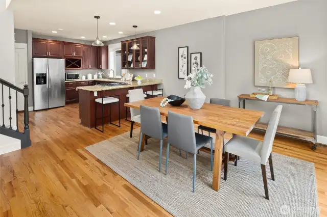 The open-concept main level invites easy flow, where natural light, rich wood tones, and newly refreshed white trim create an elevated everyday feel.