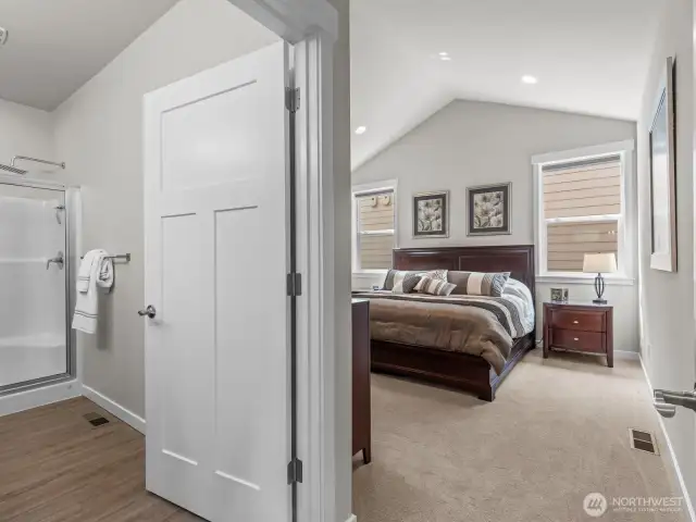 Plush carpet leads you into the generously sized primary bedroom.