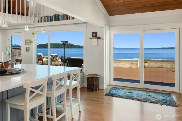 Fir tongue and groove vaulted ceiling, new floor to ceiling windows, and new oak flooring are just a few of the recent improvements. The open concept home flows beautifully from the inside to the outdoors. Blake Island in the distance.