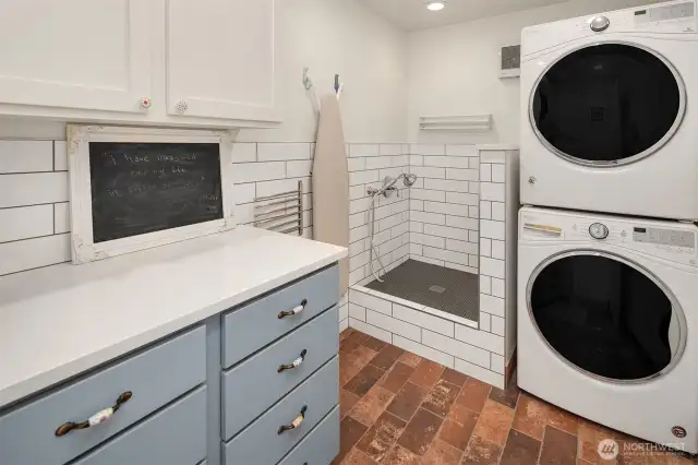 The multi-purpose room for laundry and showering your pooch sits next to the garage entrance off the living room.