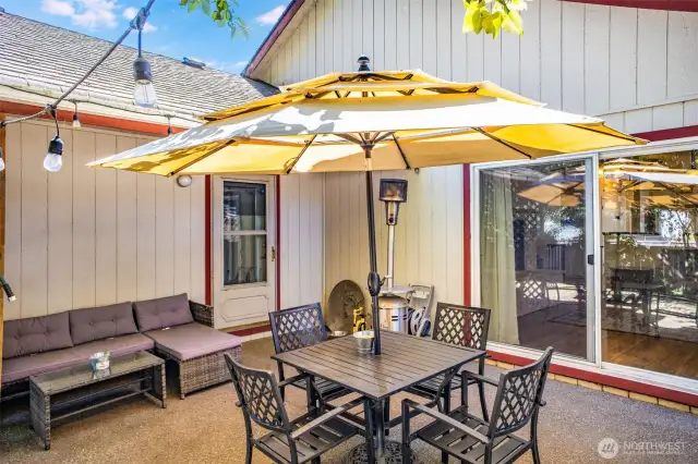 Patio area. Slider leads into living room, and man door into primary bedroom.
