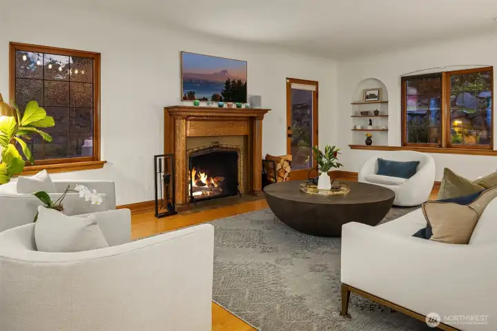 Original wood burning fireplace in the formal living room.  The door leads to a huge Trex deck with several sitting areas.