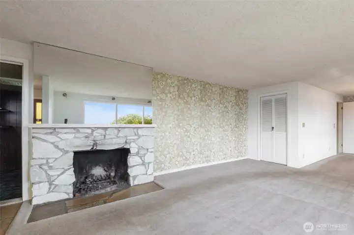 Living room has a lovely stone fireplace