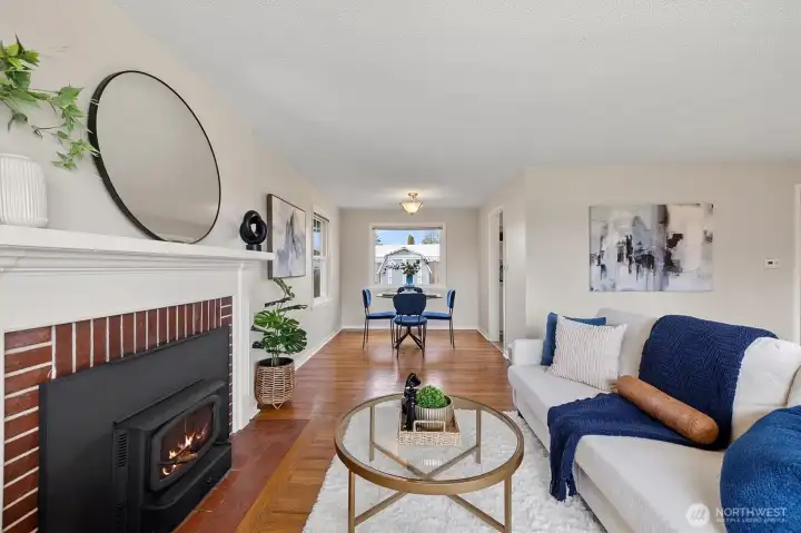 Cozy living room with rustic wood-burning fireplace, perfect for entertaining.