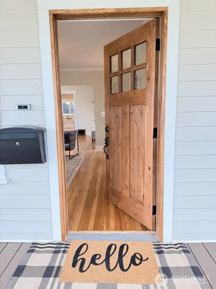 Newly installed, beautifully stained wood front door makes a stunning first impression—warm, rich, and inviting. It’s the kind of welcome that instantly feels like home.