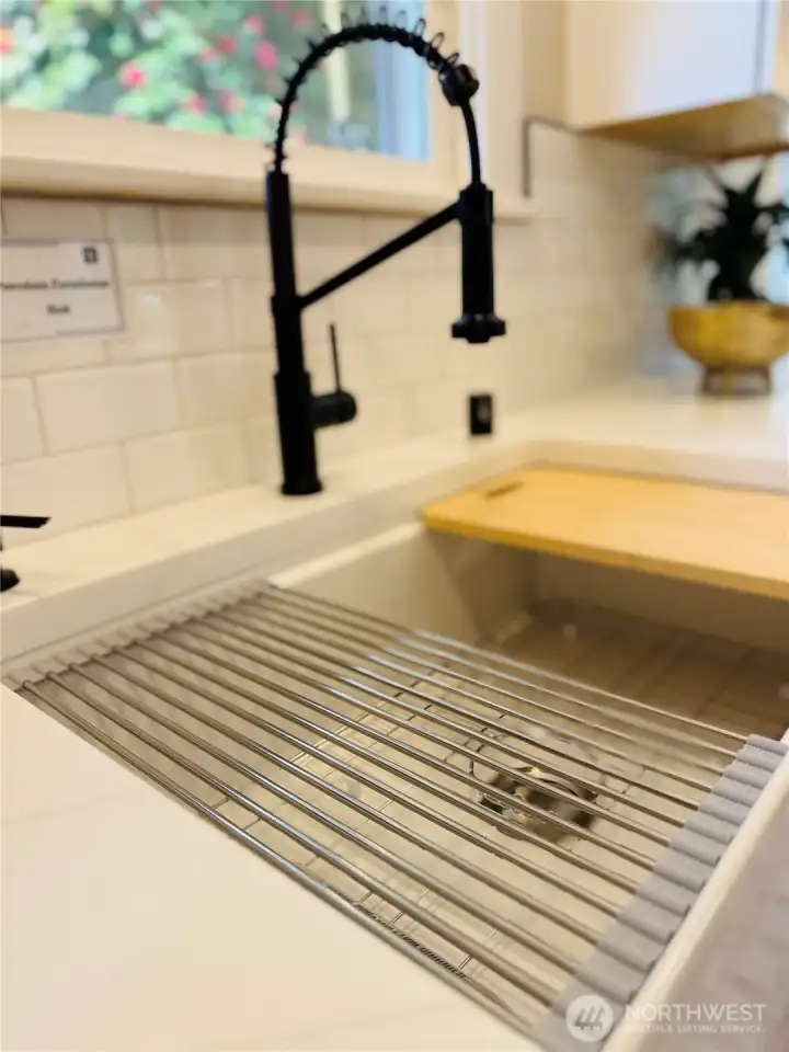 Beautifully updated kitchen with crisp white cabinetry, quartz counters, and stainless appliances—clean, bright, and effortlessly functional. Farmhouse sink and subway tile add timeless appeal, while the cozy breakfast nook invites slow mornings and casual dining. A space that truly feels like the heart of the home.”