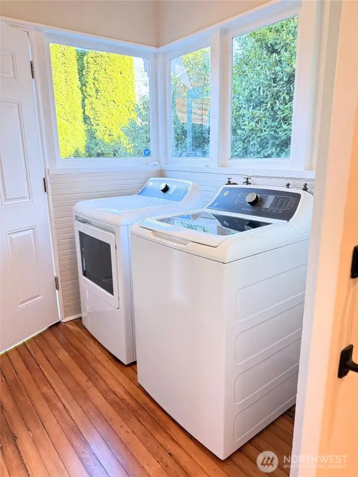 Bright and functional laundry area with newer washer and dryer, thoughtfully placed near windows for natural light—making everyday tasks feel easy and efficient.