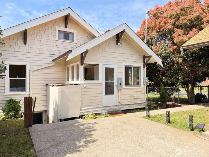 Just off the utility room, step out to a private patio and detached garage—complete with a covered area perfect for outdoor lounging or entertaining. A versatile extension of the home, ideal for gatherings, projects, or relaxed everyday living.