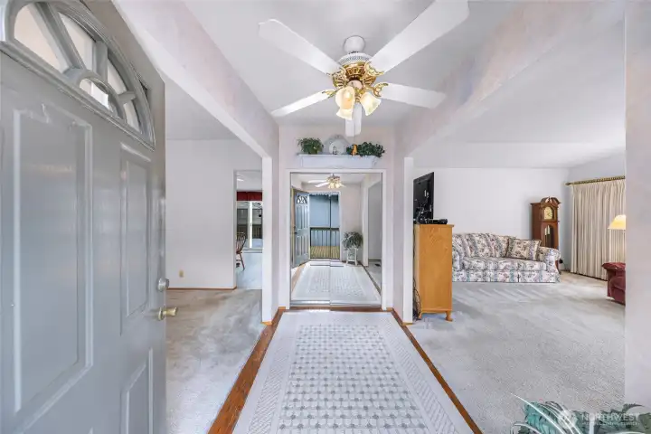 Welcoming front entry! Flexible layout offers a family room or office space to the left, spacious living room to the right, and a mirrored coat closet straight ahead that enhances the open feel