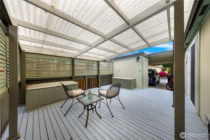 Expansive covered deck with privacy screening creates a true outdoor living space